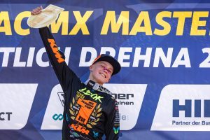 Lucas Leok reißt das Golden Plate nach dem Titelgewinn im ADAC Junior Cup 125 stolz nach oben